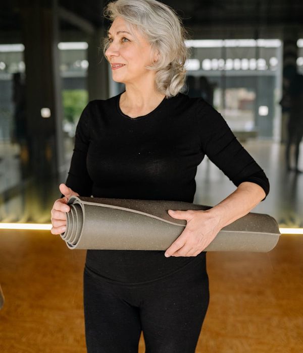 Woman holding a challenging yoga pose demonstrating strength.